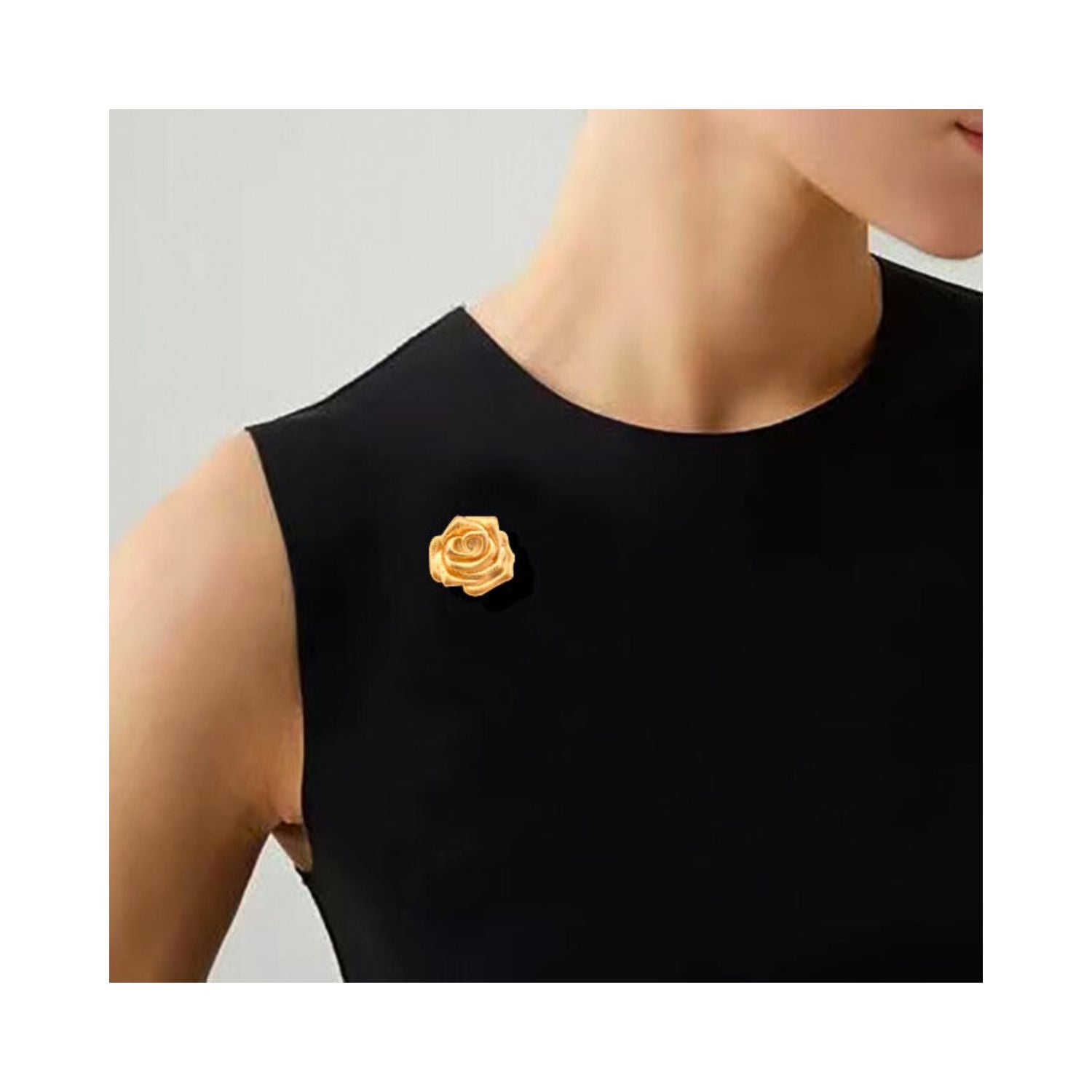 A Rose Is a Rose gold rose brooch worn on a black dress, showing elegant floral styling and a refined golden statement accent.