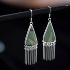 Bamboo green Song Brocade triangle fringe dangle earrings with long silver-tone fringe on a dark background.