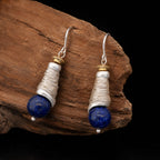 Celestial Swirl lapis lazuli spiral silver drop earrings with hand-wrapped wire on rustic wood.