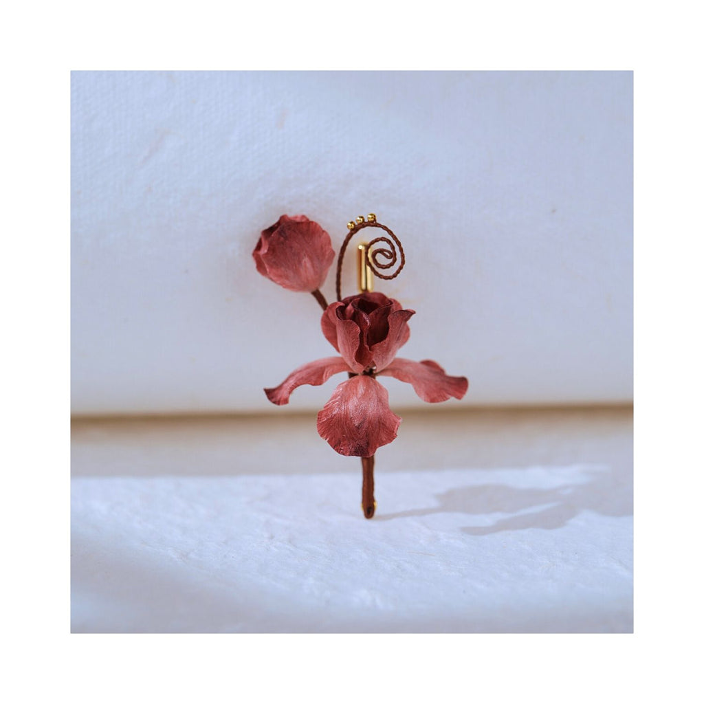 Front view of Cloud Iris mulberry silk Ronghua iris brooch on a light background, highlighting curled tendrils, layered petals, and handcrafted floral form.