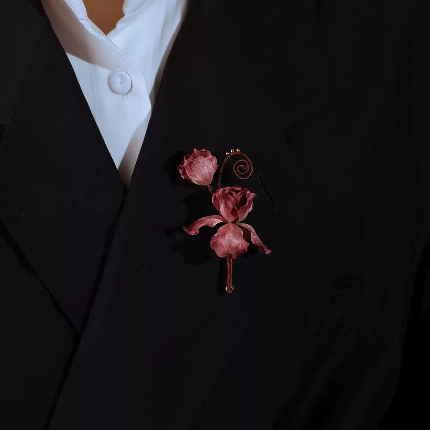 Cloud Iris Ronghua silk flower brooch worn on a black blazer with soft handmade floral detail.