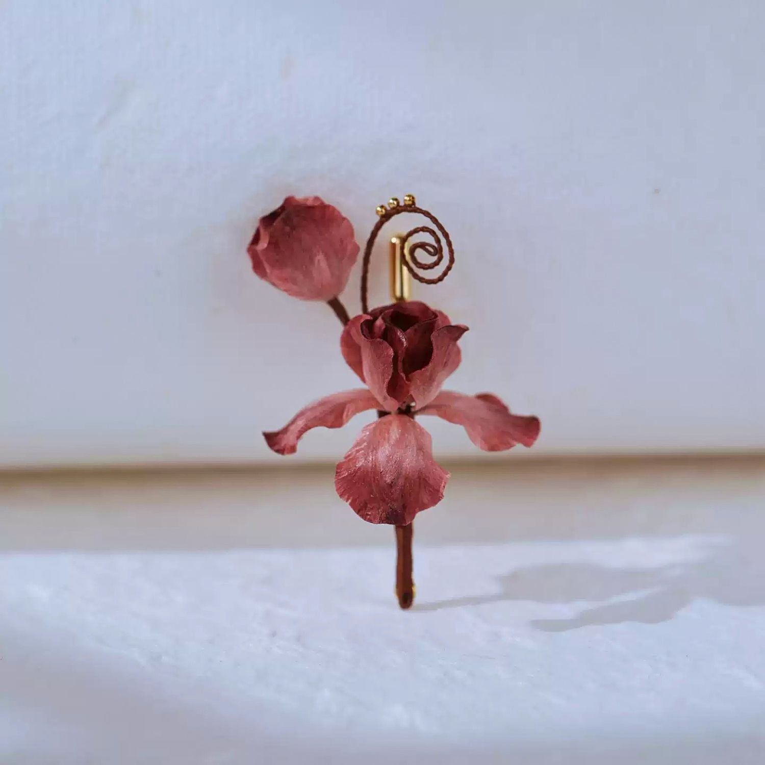 Side detail of Ronghua silk iris brooch showing dimensional floral shape and delicate wire structure.
