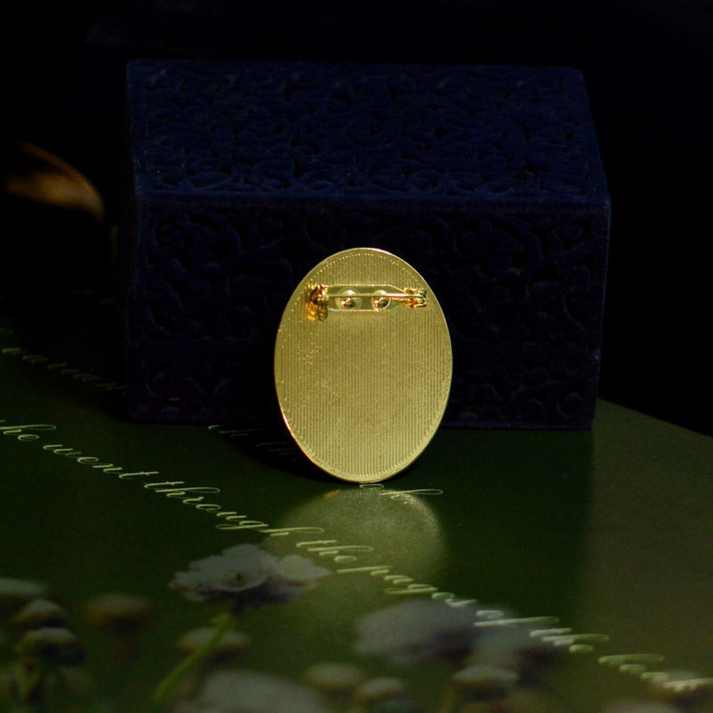 Back detail of a custom mother-of-pearl inlay brooch showing the gold-tone pin setting.