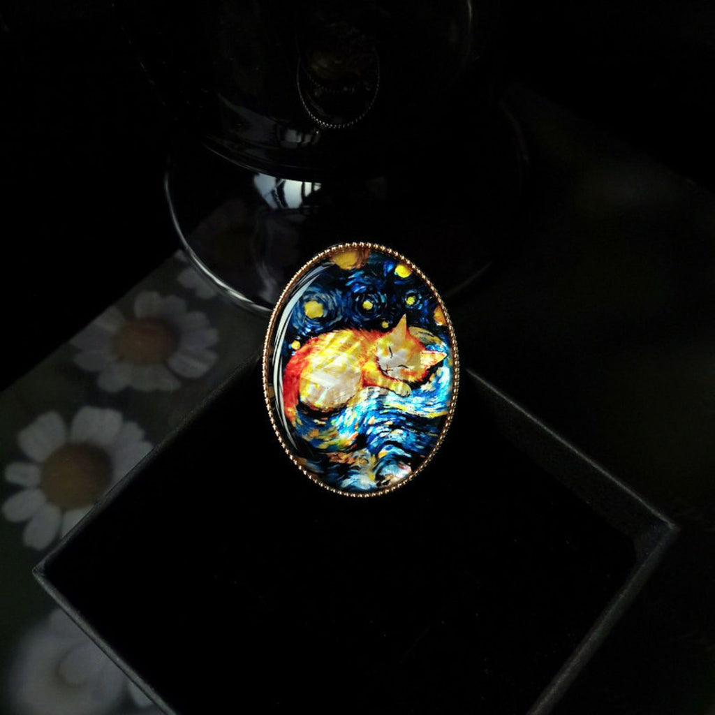 Custom mother-of-pearl inlay cat brooch with colourful shell artwork and polished brooch setting.