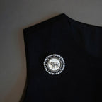 Vintage elephant pearl brooch pinned on a black top, showing scale and lapel styling.