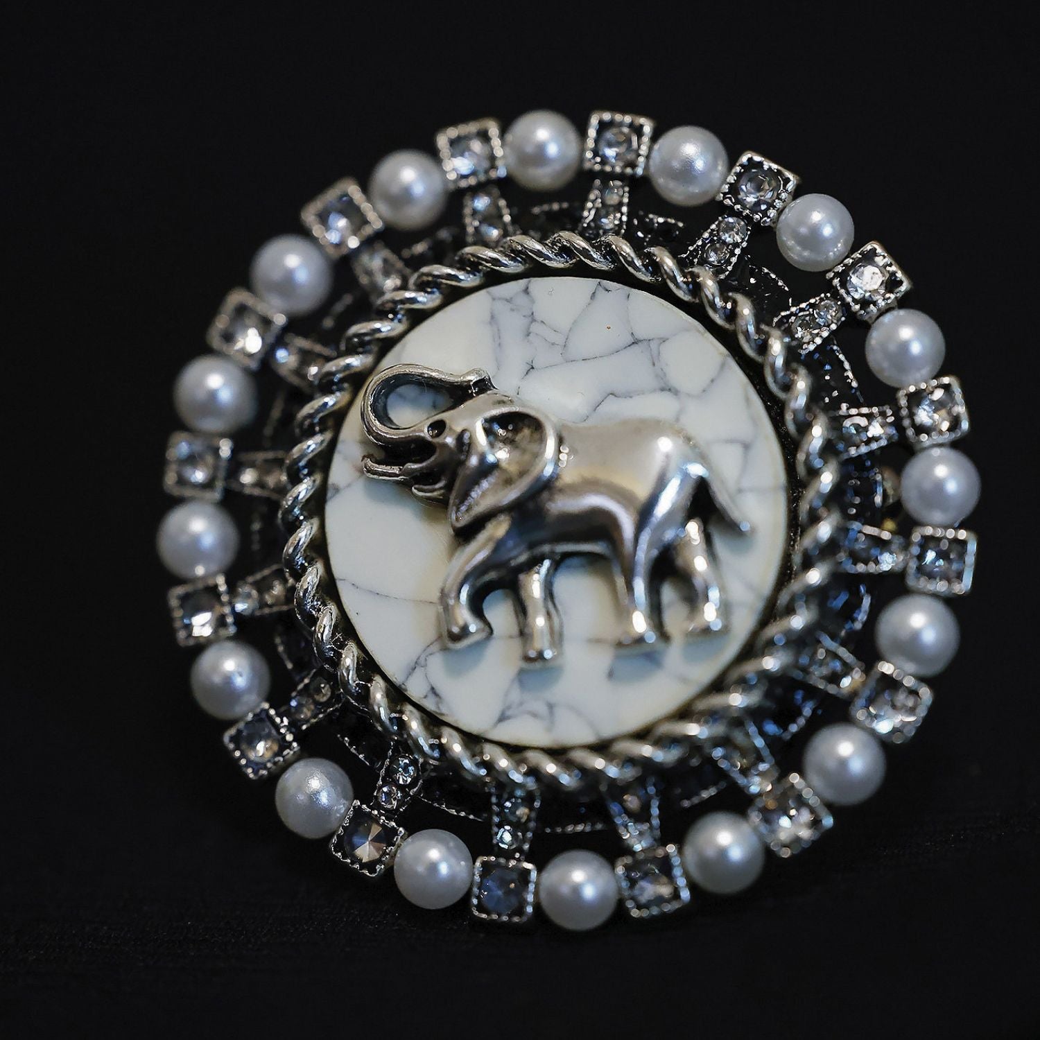 Gentle Guardian vintage elephant pearl brooch with faux pearl frame and aged silver-tone detail.