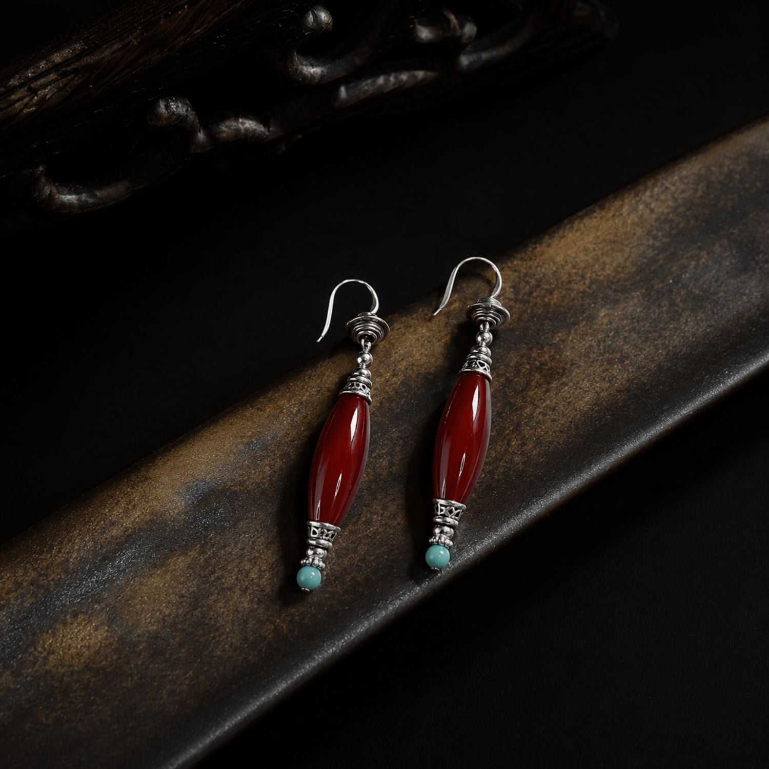 Jinherit Ancient Ember red agate and turquoise drop earrings shown in close product detail, featuring polished natural stones, antiqued silver-tone components, and hook earring construction.