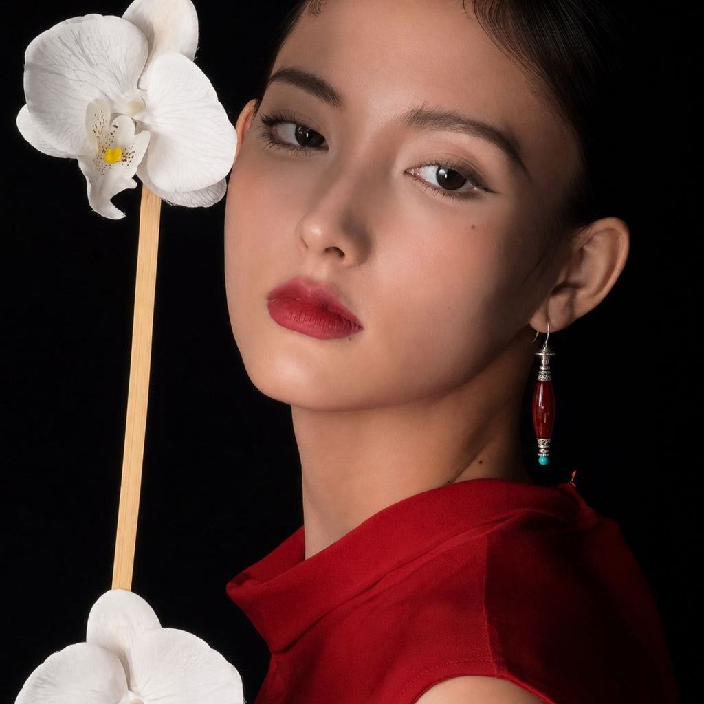 Jinherit Ancient Ember red agate and turquoise drop earrings worn by a model, highlighting the face-framing drop, rich red gemstone tone, and heritage-inspired elegance.