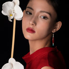 Jinherit Ancient Ember red agate and turquoise drop earrings worn by a model, highlighting the face-framing drop, rich red gemstone tone, and heritage-inspired elegance.