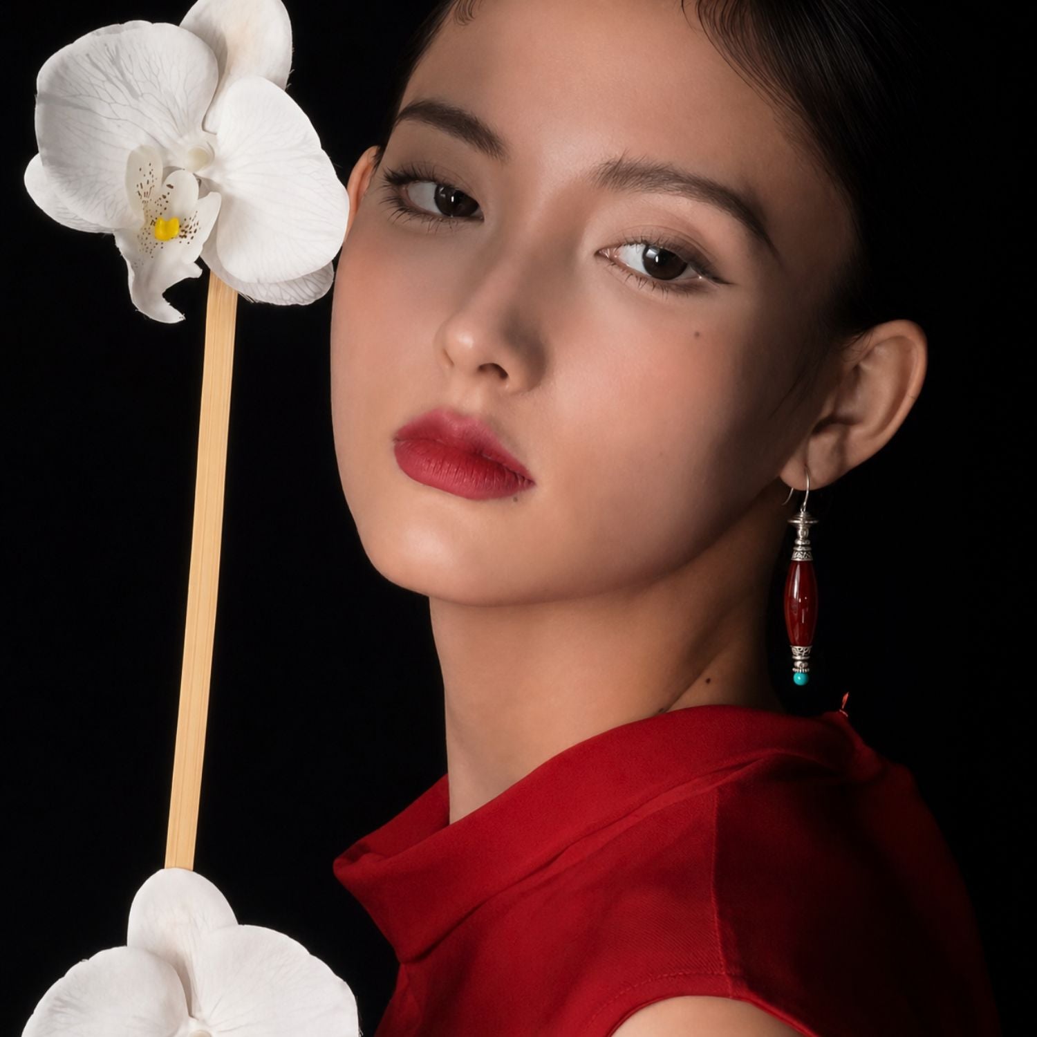 Jinherit Ancient Ember red agate and turquoise drop earrings worn by a model, highlighting the face-framing drop, rich red gemstone tone, and heritage-inspired elegance.
