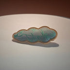 Jinherit Auspicious Cloud Song Brocade silk hair clip in Bamboo Green, showing green woven silk texture, soft brocade sheen, and heritage-inspired cloud motif.