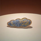 Jinherit Auspicious Cloud Song Brocade silk hair clip in Silver Blue, highlighting cool blue-silver brocade sheen, cloud-shaped frame, and refined textile detail.