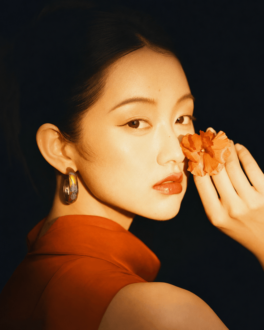 Iris Chinese lacquer hoop earrings worn by a model, artisan-made statement earrings by Jinherit.