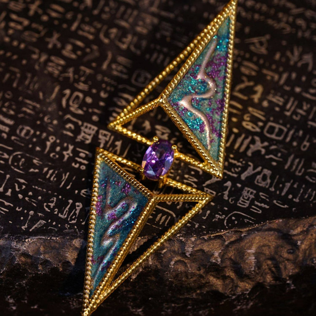 Jinherit Eye of the Desert hand-painted geometric stud earrings, featuring angular gold-edged shapes, a hand-painted surface, and a centered gemstone accent inspired by a watchful eye.