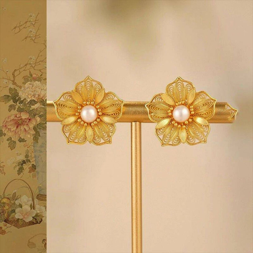 Jinherit Golden Bloom filigree pearl flower stud earrings front detail, showing layered gold-plated petals, lace-like metalwork, and luminous freshwater pearl centers.