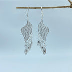Jinherit Imperial Wing silver filigree drop earrings, featuring fine openwork wire texture, layered wing silhouette, lightweight drop construction, and heritage-inspired craftsmanship.