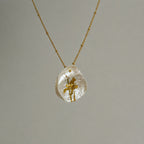Jinherit Iris on Pearl necklace pendant detail, featuring a hand-painted iris flower on a natural petal-shaped baroque pearl with soft iridescent lustre.