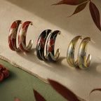 Jinherit Iris Thicket hand-painted Chinese lacquer C-hoop earrings in black, gold, and red, featuring painted iris floral motifs, a copper-base lacquer finish, and vintage botanical styling.