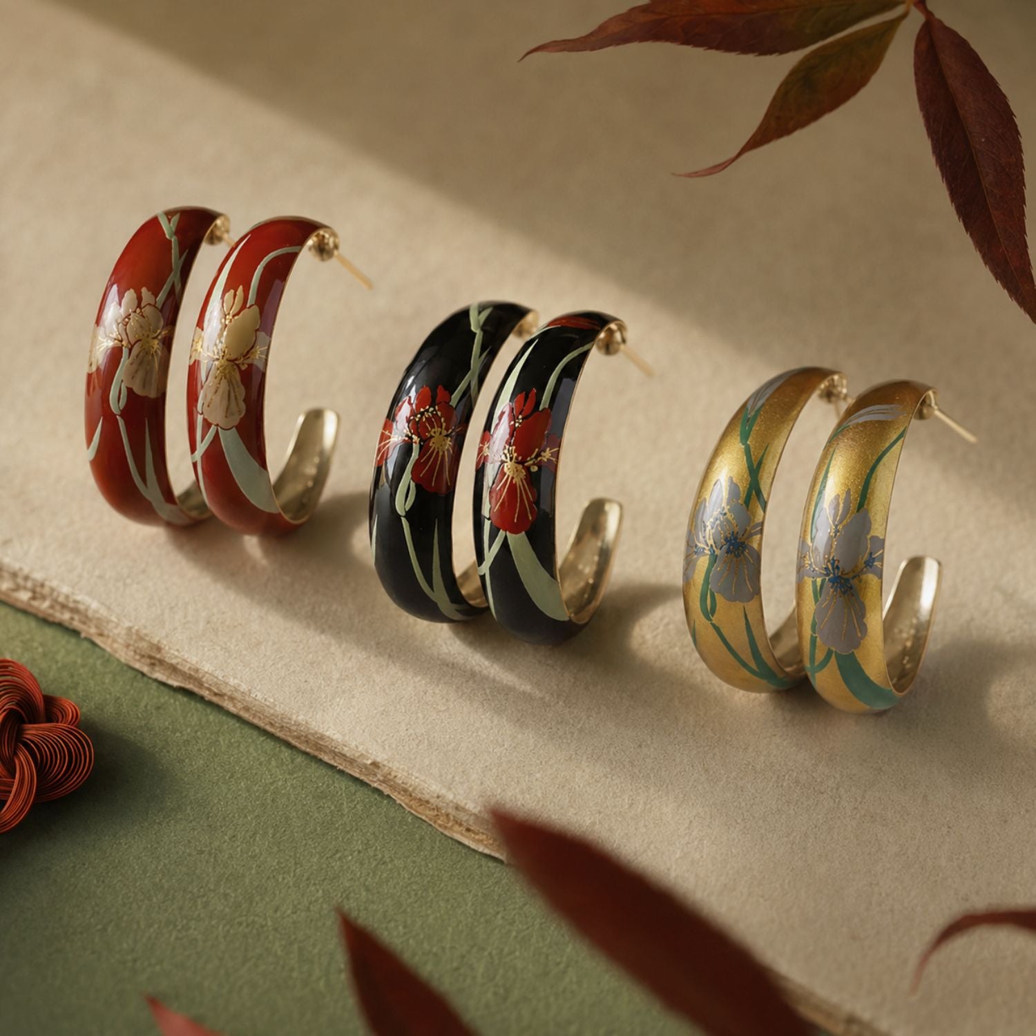 Jinherit Iris Thicket hand-painted Chinese lacquer C-hoop earrings in black, gold, and red, featuring painted iris floral motifs, a copper-base lacquer finish, and vintage botanical styling.