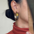 Jinherit Iris Thicket gold Chinese lacquer hoop earrings worn by a model, featuring warm lacquer tones, painted iris floral detail, and a lightweight statement hoop silhouette.