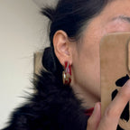 Jinherit Iris Thicket red Chinese lacquer hoop earrings worn by a model, highlighting the bold botanical color, hand-painted iris motif, and polished vintage C-hoop design.
