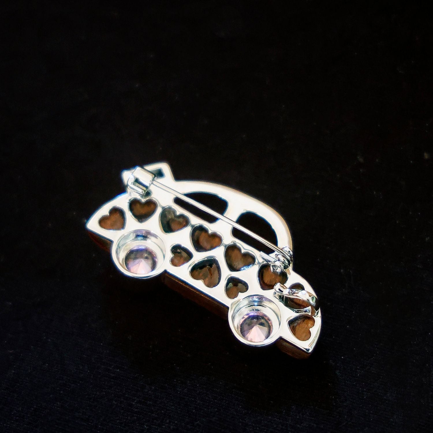 Jinherit Joyride wooden rose quartz car brooch back detail, showing the brooch pin construction, polished metal finish, open car outline, and secure wearable design.