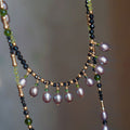 Jinherit Lustrous Tide pearl tassel wrap necklace, featuring iridescent freshwater pearls, black spinel beads, peridot accents, and 14K gold-filled details in a hand-strung layered design.