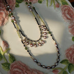 Jinherit Lustrous Tide convertible pearl tassel wrap necklace styled as a flat lay, featuring cascading freshwater pearl drops, black spinel depth, green stone accents, and antique-inspired layering.