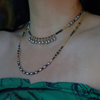 Jinherit Lustrous Tide pearl tassel wrap necklace worn in a layered style, showing its convertible double-strand look, soft pearl shimmer, and vintage-inspired elegance.