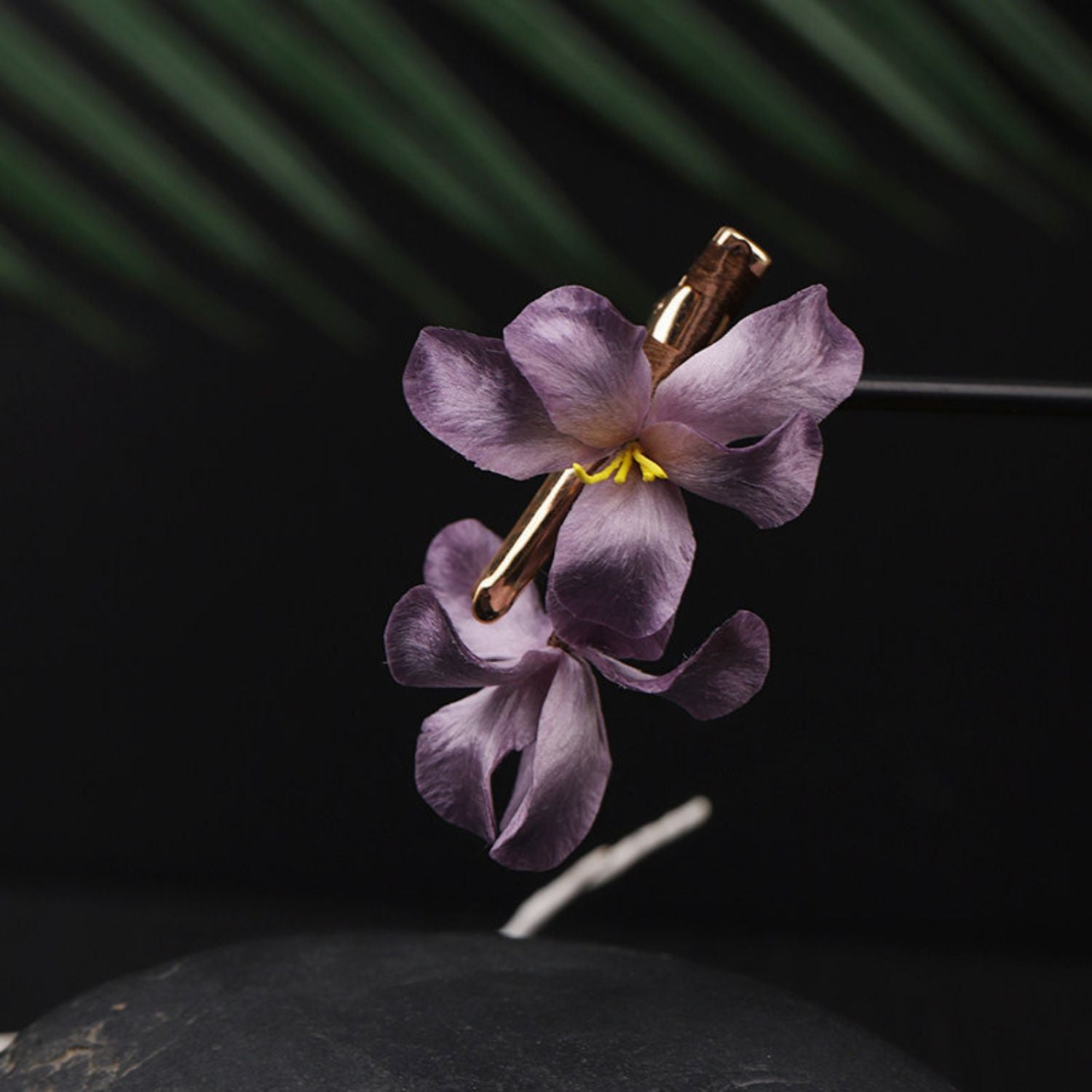 Jinherit Midnight Orchid Ronghua silk flower hair clip displayed against a dark background, featuring hand-shaped deep purple mulberry silk petals and a sculptural orchid form.