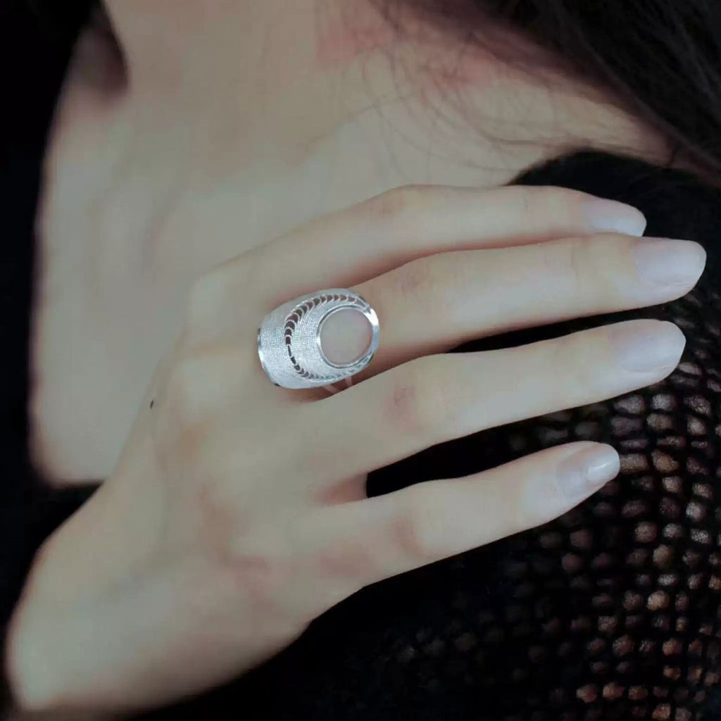 Jinherit Moon Phases filigree open ring worn as a silver statement ring, showing the airy open form, moon phase rhythm, and refined everyday styling.