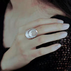 Jinherit Moon Phases filigree open ring worn as a silver statement ring, showing the airy open form, moon phase rhythm, and refined everyday styling.