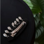 Jinherit Moonlit Garden pearl drop shell inlay hair clip displayed in dark styling, featuring luminous mother-of-pearl floral detail and elegant suspended pearls.