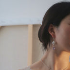 Jinherit Moonlit Lantern silver openwork drop earrings shown in side wearing view, featuring a lightweight drop silhouette, Chinoiserie-inspired detail, and soft purple glass movement.