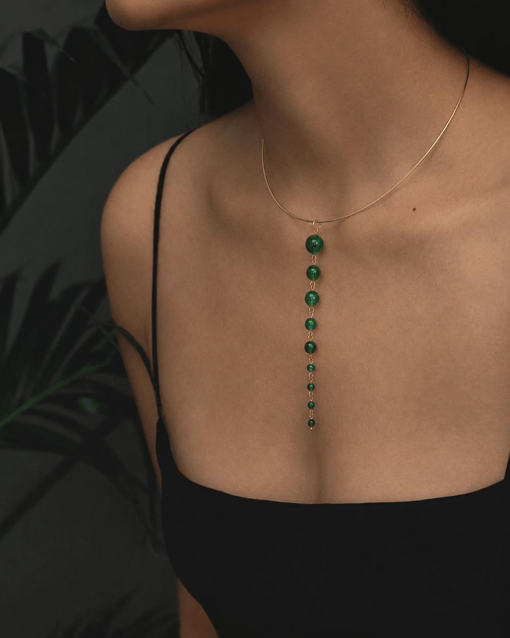 Zen Line emerald green Y-drop lariat necklace with delicate gold chain and beaded pendant.