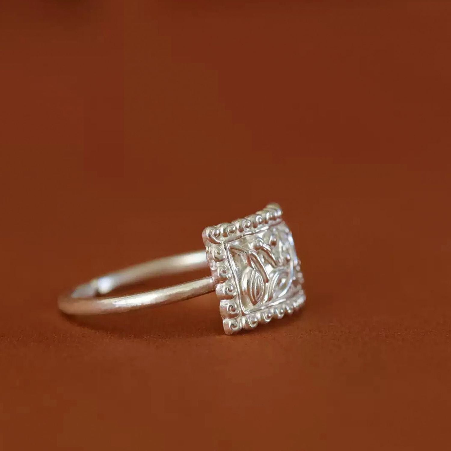 Jinherit Orchid Spirit engraved orchid silver ring profile, highlighting the raised rectangular ring face, slim S990 silver band, and refined botanical statement design.