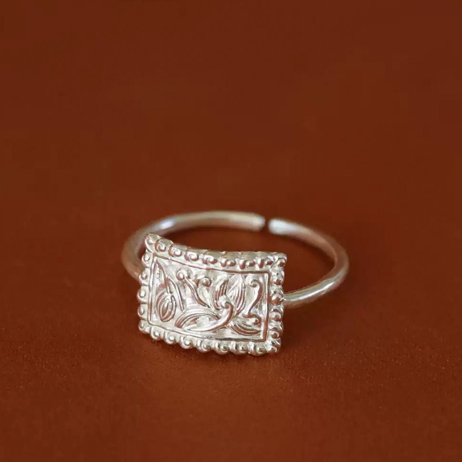 Jinherit Orchid Spirit fine silver adjustable ring side detail, showing the open-back band, engraved orchid face, and handcrafted silver texture.