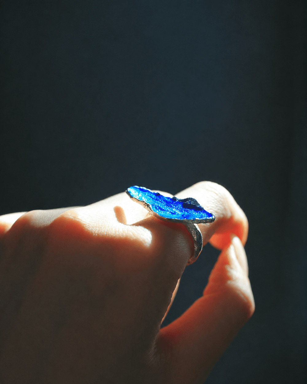 Into the Blue handcrafted enamel ring with vivid blue artisan enamel texture in a close-up shot.