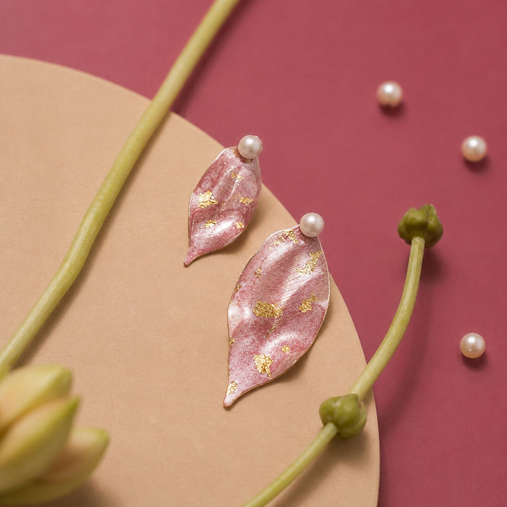 Jinherit Spring Reverie asymmetric hand-painted petal earrings front detail, featuring soft pink petals, freshwater pearl studs, and delicate 14K gold leaf accents.