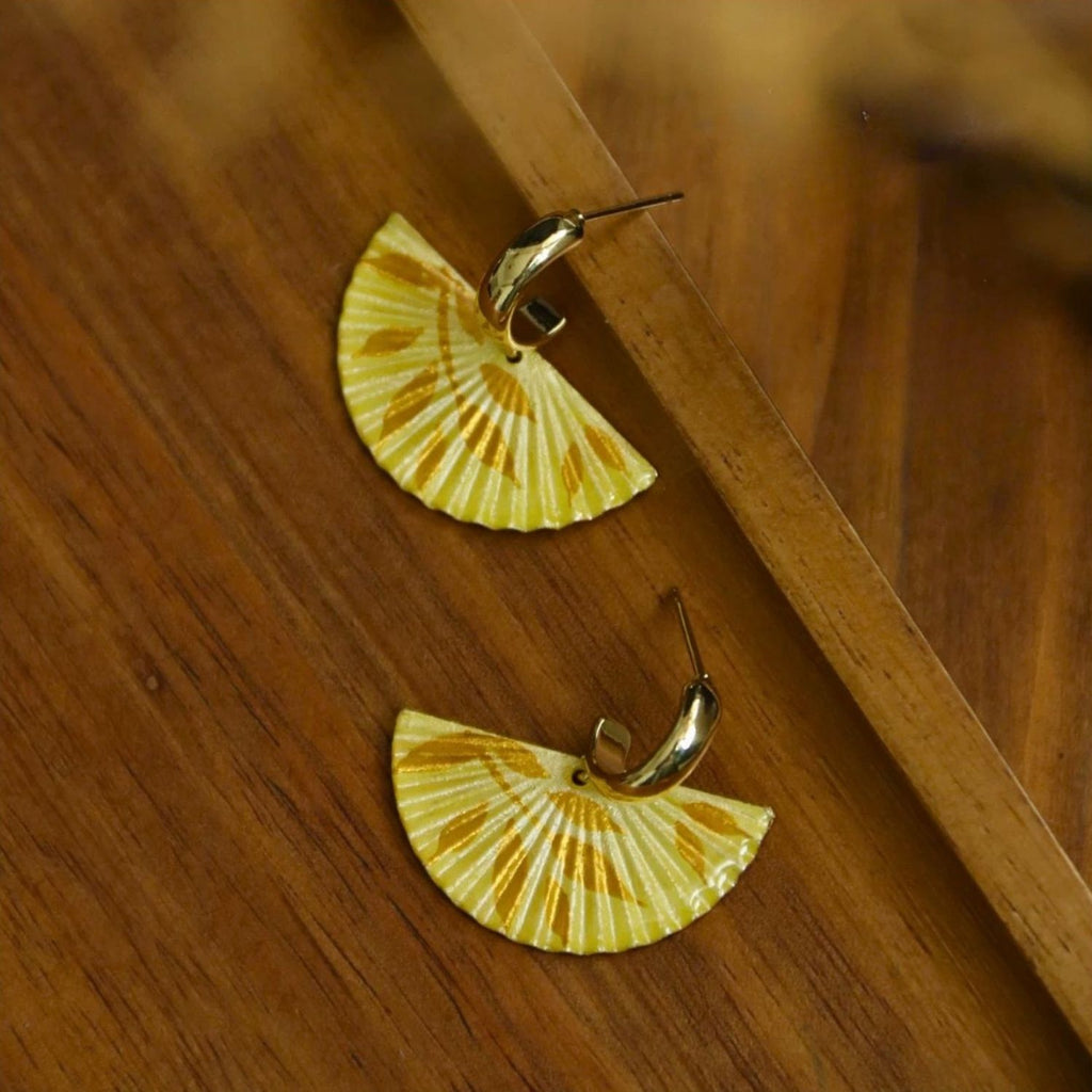 Jinherit The Four Seasons hand-painted fan dangles in Autumn Echo, featuring golden yellow fan earrings with artisanal painted texture and warm fall-inspired tones.
