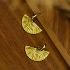 Jinherit The Four Seasons hand-painted fan dangles in Autumn Echo, featuring golden yellow fan earrings with artisanal painted texture and warm fall-inspired tones.
