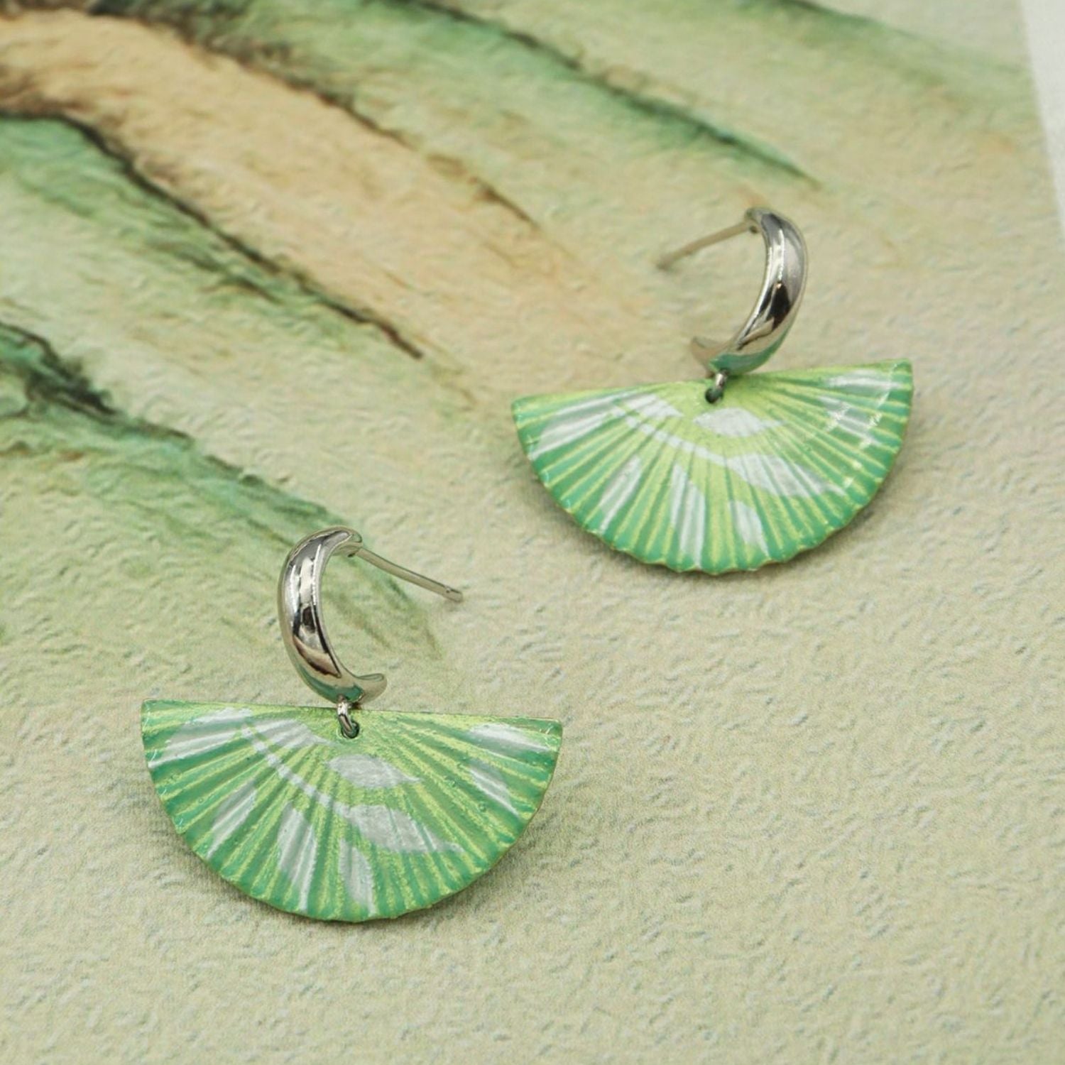 Jinherit The Four Seasons hand-painted fan dangles in Spring Awakening, featuring green fan-shaped earrings with artisan brushwork, botanical tones, and a graceful dangle silhouette.