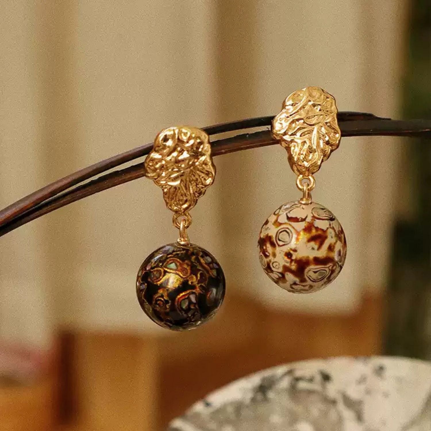Jinherit Zen Lacquer mother-of-pearl inlay drop earrings, featuring Chinese lacquer bead drops in black and white tones, luminous shell inlay, and sculptural gold-tone tops.