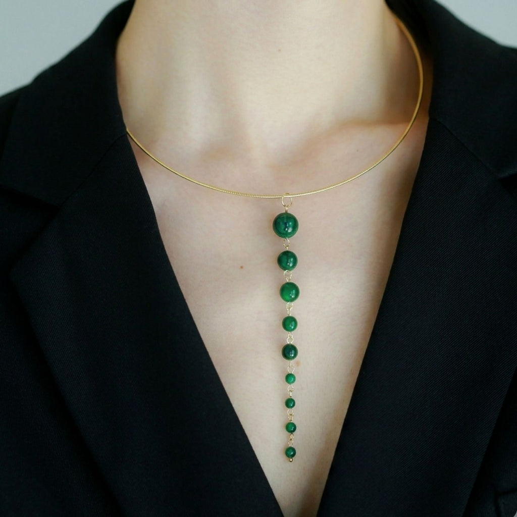 Jinherit Zen Line emerald-green Y-drop lariat necklace worn by a model, featuring a gold-tone collar necklace with a vertical cascade of graduated green beads and a refined minimalist silhouette.