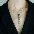 Jinherit Zen Line emerald-green Y-drop lariat necklace worn by a model, featuring a gold-tone collar necklace with a vertical cascade of graduated green beads and a refined minimalist silhouette.