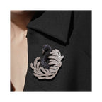 Jinherit Midnight Grace black swan brooch pin worn on a blazer lapel, showing statement styling, silver-tone feather detail, and cool midnight sparkle.