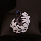 Close-up of black swan crystal brooch with sculptural feather lines, zircon stones, and midnight blue accents.