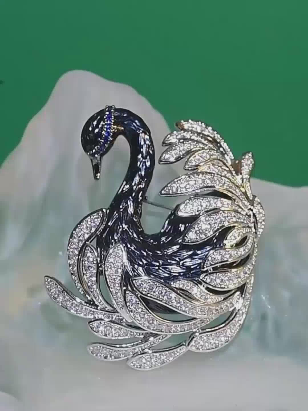 Jinherit Midnight Grace black swan crystal brooch detail video showing sculptural swan form, pavé zircon feather lines, Austrian blue crystal accents, and statement brooch styling.