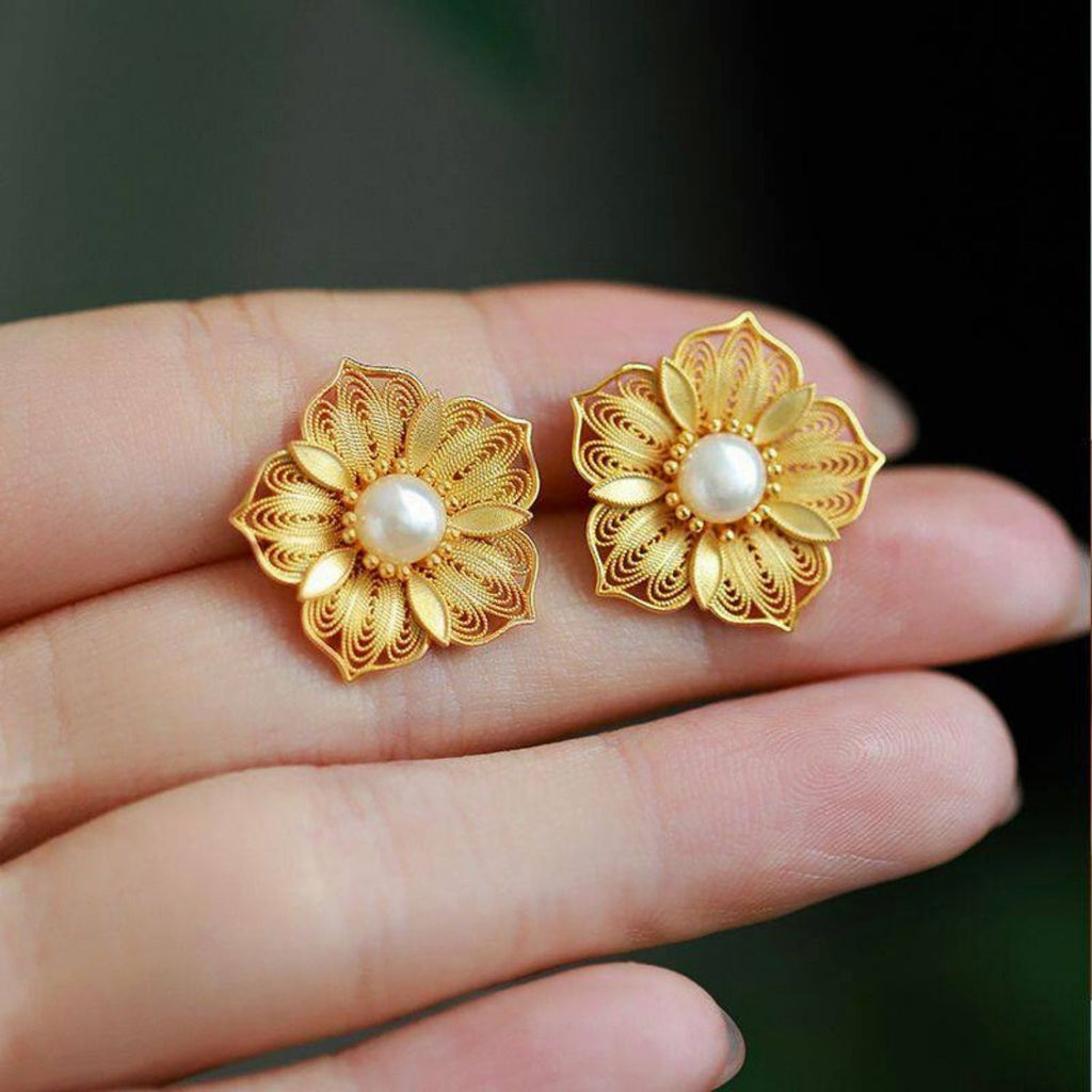 Jinherit Golden Bloom filigree pearl flower studs shown in a wearing detail video, highlighting gold-plated openwork petals, freshwater pearl centers, and a graceful floral silhouette.