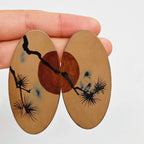 Jinherit Pine & Moon hand-painted Chinese lacquer drop earrings video detail, highlighting the lacquer gloss, hand-painted pine branches, burnt-orange moon, brass base, and 925 silver hooks.